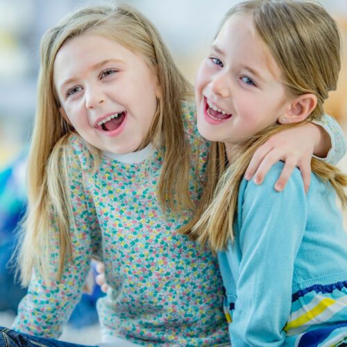 Two little girls hugging