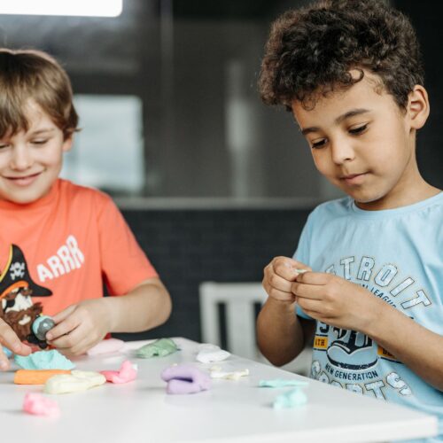 Two little boys playing with dough