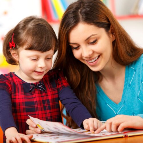 mom reading with preschooler daughter